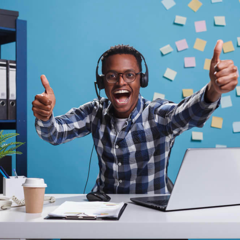 overjoyed-smiling-call-center-operator-showing-thumbs-up-gesture-with-hands-while-looking-camera-happy-cheerful-customer-support-representative-indicating-that-client-problem-is-solved (1)